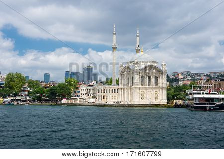 ISTANBUL TURKEY - JUNE 25 2015: Ortaköy Mosque (Grand Imperial Mosque of Sultan Abdulmecid) in Istanbul Turkey is situated at the waterside of the Ortakoy pier square one of the most popular locations on the Bosphorus