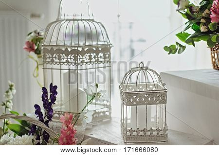 White Decorative Cage With Flowers And Leaves In Day Light
