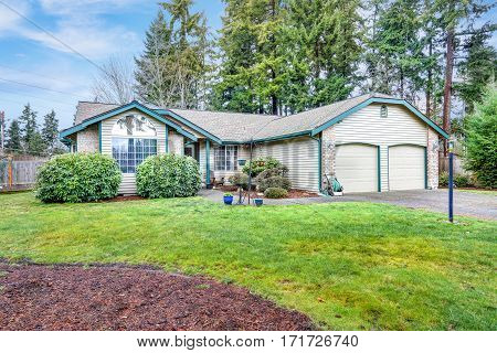 Lovely Beige Rambler House Exterior With Two Garage Spaces