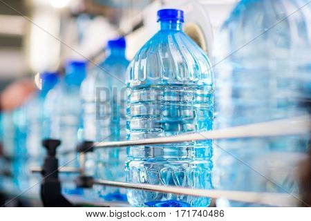 Plastic water bottles on conveyor and water bottling machine industry