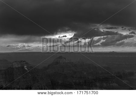 A black and white photo of a storm approaching over the Grand Canyon.