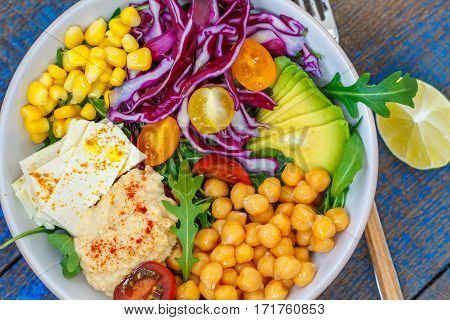 Vegan salad with hummus tofu chickpeas and vegetables. Love for a healthy vegan food concept