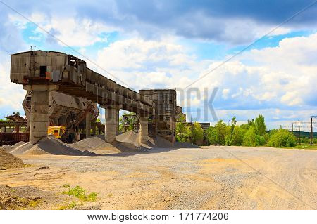 Stone quarry with silos and conveyor belts. Industrial equipment. Mining
