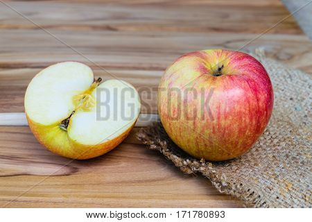 apple on sack on wooden table background