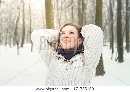 Young beautiful woman walking in the park in winter outdoor.