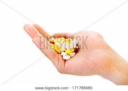 Person hold a Pills in the Hand Isolated on the White Background closeup