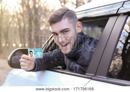Woman with driving license in car