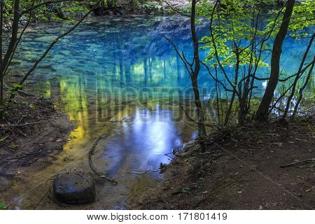 Azure pond. Natural lake in romanian forest