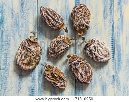 Dried persimmon on blue wooden background