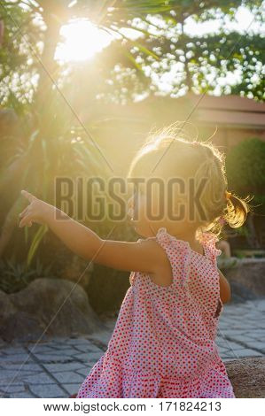 Beautiful Little Girl Is Sitting On A Rock The Sunset. Towers Ponagar. Vietnam.