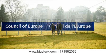 STRASBOURG FRANCE - FEB 2 2017: Workers taking care of the Council of Europe Conceil de Europe blue signage in front of the international organisation focused on promoting human rights democracy and the rule of law in Europe