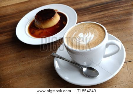 Coffee Cup With Latte Art And Pudding On The Wood Table