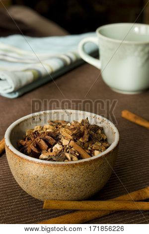 An earthy bowl filled with mulling spices.