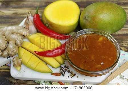 Bowl of homemade frsh Mango Chutney on old wooden table