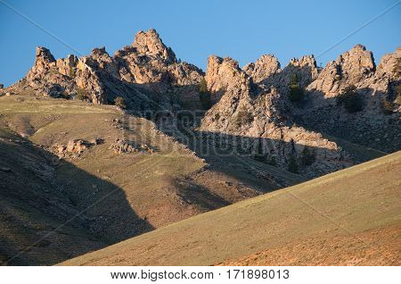 The rocks on the mountain against the blue sky