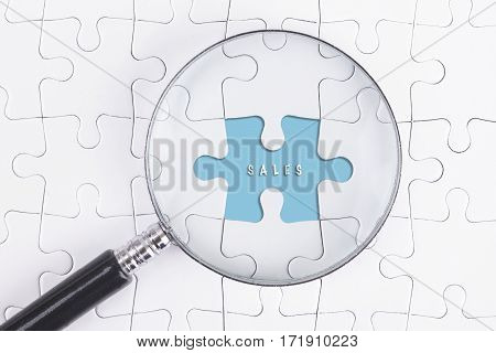 Business Concept - Magnifier Glass on white puzze with DISCOUNT Word