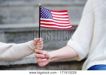 Young Woman And Little Child Holding American Flag