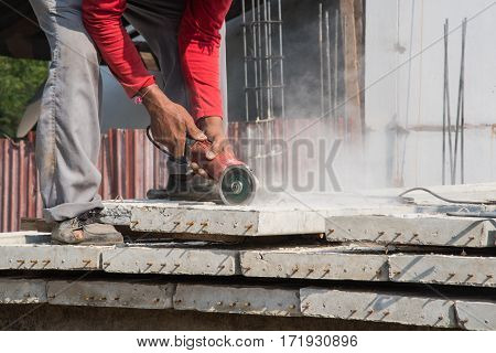 Builder Worker With Grinder Machine Cutting Concreate Floor At Construction Site