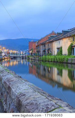 Otaru Japan historic canal and warehouse in summer twilight time people are walking alongside the canal famous tourist attraction of Sapporo Hokkaido.