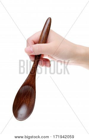 Hand holding wooden spoon isolated on white background