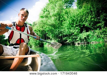 young people canoeing on the neckar river in germany.