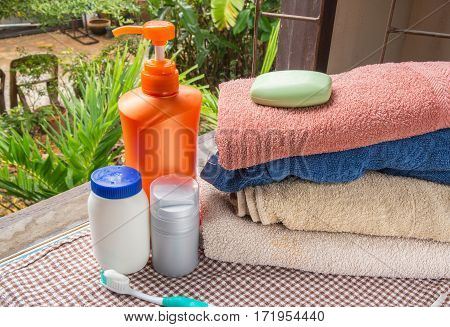bath soap a towel and cosmetics on table.