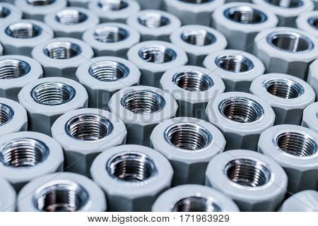 PPR Plumbing connection fittings for plastic pipes. Orderly arranged in neat rows. Abstract industrial background.