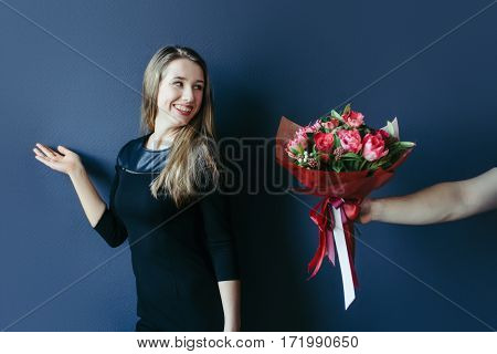 Before date. Girlfriend getting bouquet of red tulips. Boyfriend giving tulips gift present to his girl.