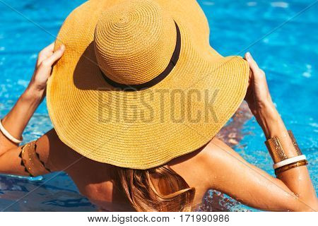 Young Blond Girl Has A Rest At The Pool. Rear View. Summertime
