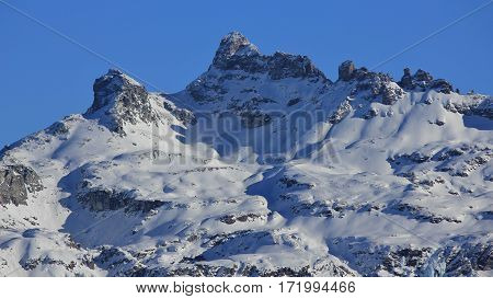 Snow covered mountain Gross Charpf. Mountain in Glarus Canton. View from Braunwald.