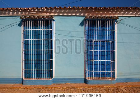 Typical colonial building with white window grate in Trinidad Cuba