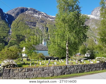 Cemetery And Church Surrounded By Trees And Mountains In Eidfjord, Norway.