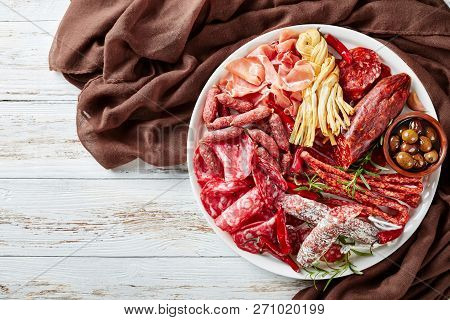 A Set Of Spanish Sausages And Dry Cured Meat - Jamon, Chistorra, Chorizo, Salchichon, Fuet, Olives, 