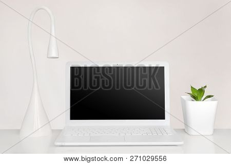 Laptop, Lamp And Plant In Pure Interior. Totally White Modern Workspace Concept.