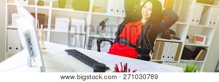 A Beautiful Young Girl Leaned Back In Her Office At The Table.