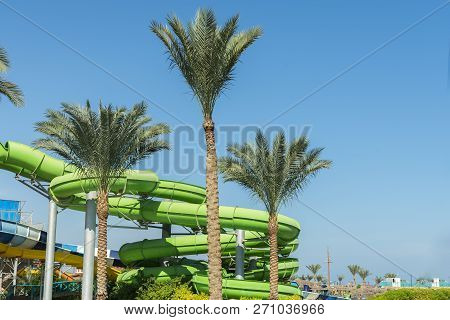 Colorful Slides And Pool In Aqua Park. Place To Have A Rest And Family Fun. Long, Green Waterslide I