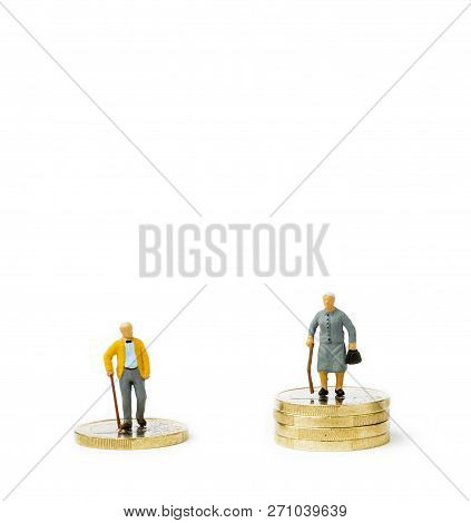 Small Figurines And Stacks Of Euro Coins On Bright Background. Economic Inequality By Gender. Inequa