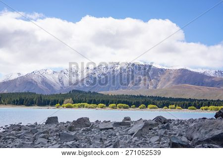 Ruataniwha Inlet Foreshore At Low Tide With Snow On Top Distant Mountains Under Dramaitc Clouds At C