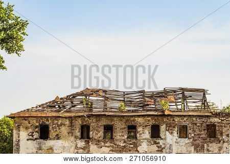Old Abandoned Dilapidated Residential Building. Damaged Roof.