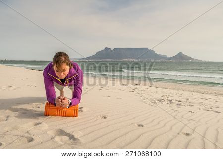 Fitness Model Exercising In Front Of Table Mountain