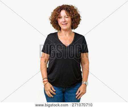 Beautiful middle ager senior woman over isolated background winking looking at the camera with sexy expression, cheerful and happy face.