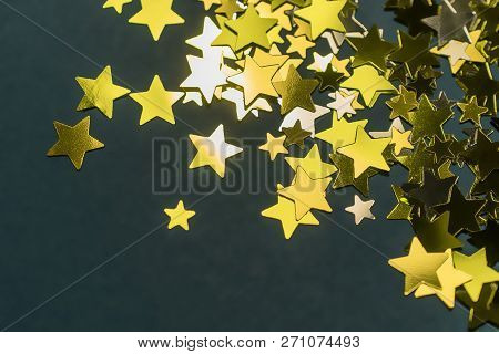 Golden Confetti Stars Scattered On The Surface.