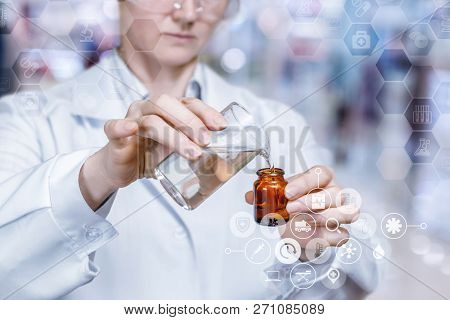 A Laboratorian In Safety Glasses Is Making A Medical Substance Adding Some Elements Into The Bottle.
