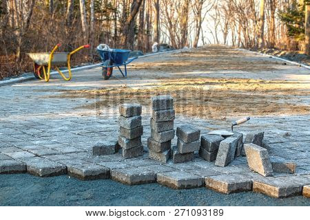 Construction Site And Paving On A Walking Path In A Public Park. Scene Of Preparatory Work With Cart