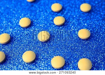 Small Yellow Orange Beautiful Medical Pharmaceptic Round Pills, Vitamins, Drugs, Antibiotics On A Bl