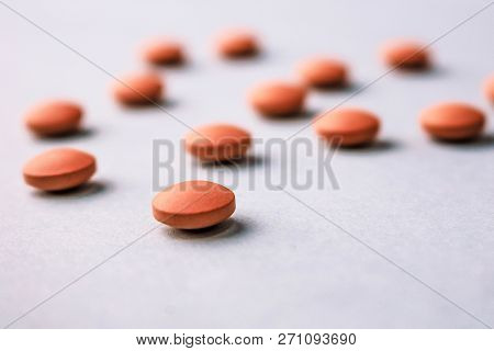 Small Yellow Orange Beautiful Medical Pharmaceptic Round Pills, Vitamins, Drugs, Antibiotics On A Bl