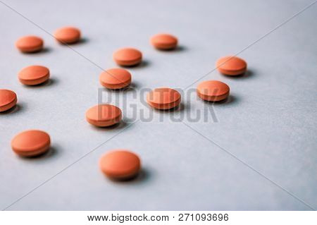 Small Yellow Orange Beautiful Medical Pharmaceptic Round Pills, Vitamins, Drugs, Antibiotics On A Bl