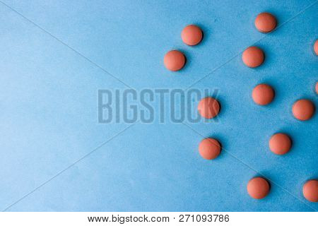 Small Yellow Orange Beautiful Medical Pharmaceptic Round Pills, Vitamins, Drugs, Antibiotics On A Bl
