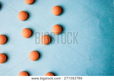 Small Yellow Orange Beautiful Medical Pharmaceptic Round Pills, Vitamins, Drugs, Antibiotics On A Bl