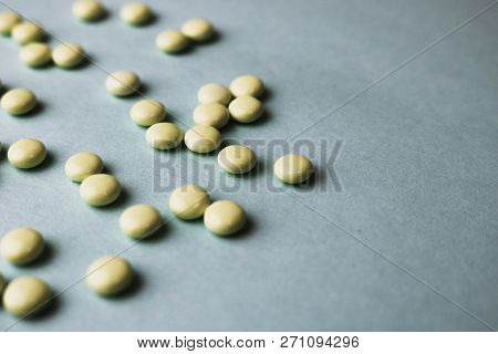 Small Yellow Orange Beautiful Medical Pharmaceptic Round Pills, Vitamins, Drugs, Antibiotics On A Bl